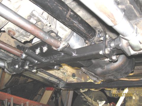 1994 Ford Bronco - Close-up of the vehicle's drivetrain components, including the transmission and driveshaft, with custom fabrication visible.