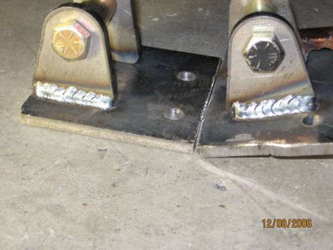1994 Ford Bronco - Close-up of welded metal brackets on a concrete surface, dated 12/08/2006.