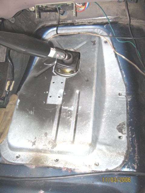 1994 Ford Bronco - Close-up of the interior floor pan and shifter assembly, showing metalwork and wiring.