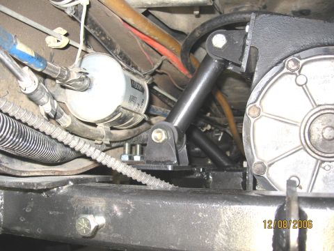 1994 Ford Bronco - Close-up of vehicle undercarriage showing a fuel filter and newly installed crossmember components.
