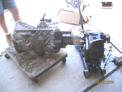 1994 Ford Bronco - Transmission and transfer case components are shown on a dolly and jack.