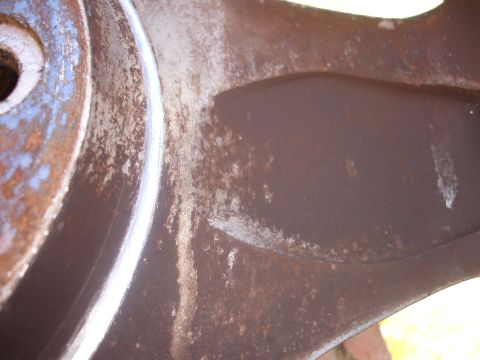 1993 Ford Taurus - This is a close-up view of a vehicle's brake rotor and caliper, showing signs of rust and wear.