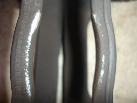 1993 Ford Taurus - A close-up view of a brake caliper shows some white residue on its surface.