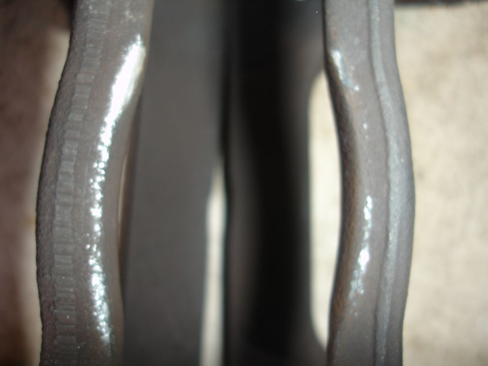 Close-up of a gray brake caliper with white residue