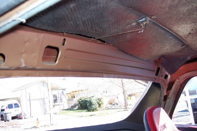 1972 Ford Ranchero - Interior view of a 1972 Ford Ranchero, revealing its exposed metal roof and red seat details.