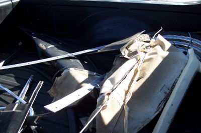 1972 Ford Ranchero - Disassembled car interior parts are piled in the bed of a pickup truck.
