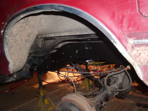 1991 Ford Bronco - The rear axle and suspension system of a vehicle are visible, undergoing maintenance or repair.