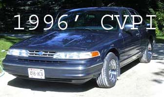 1996 Ford Crown Victoria - 1996 Ford Crown Victoria CVPI shown in a front 3/4 view. The vehicle is dark blue and has a text overlay indicating the year and model.