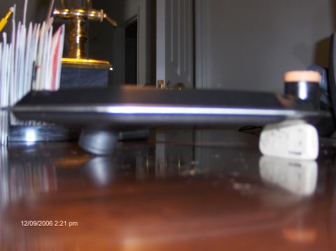 2004 Ford Crown Victoria - A section of a car dashboard is visible, resting on a white object on a wooden surface.