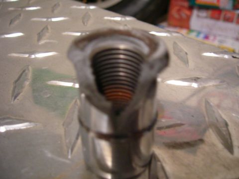 1979 Ford Bronco - A threaded metal component is shown in detail against a textured metallic background.