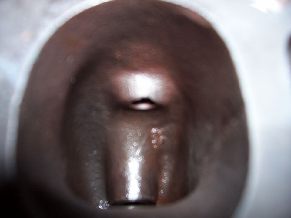Engine cylinder interior, dark brown with light reflections