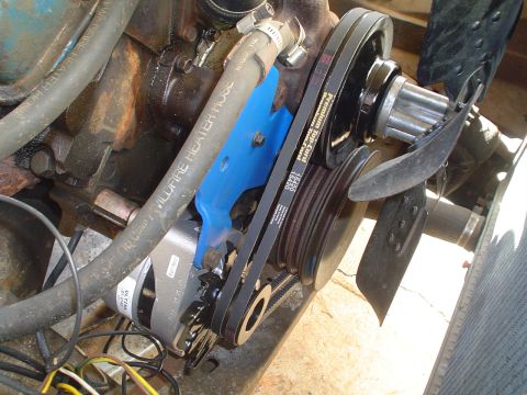 1967 Ford F-250 - Close-up view of an engine's accessory drive system, including the alternator, belts, and pulleys.