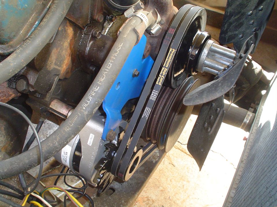 Engine close-up showing belts, pulleys, and alternator