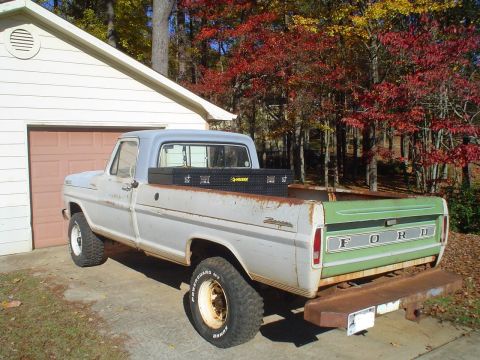 1967 Ford F-250 - This 1967 Ford F-250 pickup truck is seen from the rear with a green tailgate and white lettering.