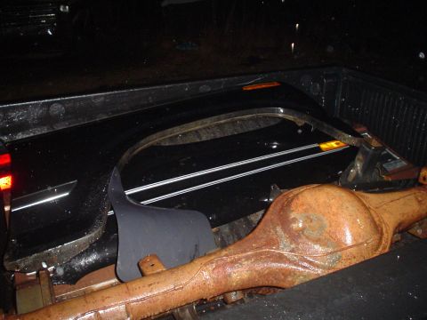 1984 Ford Bronco - Rear axle and fender flare are visible in the bed of a pickup truck.