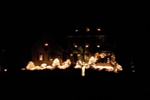 1996 Mercury Grand Marquis - House decorated with Christmas lights at night.