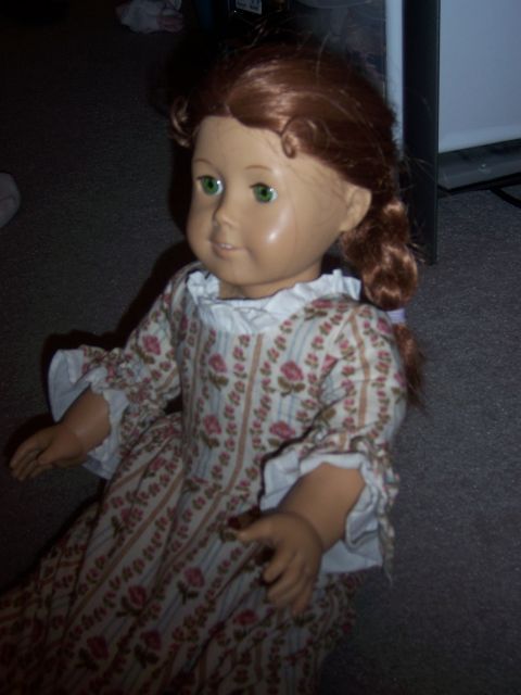 1987 Volkswagen Golf - A doll wearing a colonial-style dress is pictured indoors.