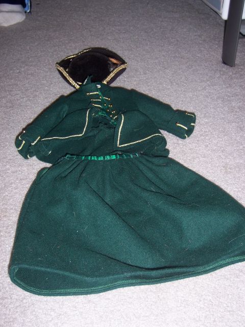 1987 Volkswagen Golf - Green historical costume with hat laid out on carpet.