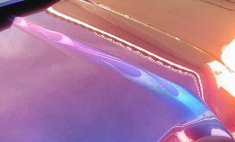 1968 Mercury Cougar - Custom flame graphics adorn the hood of this vehicle, with a metallic purple base coat and vibrant flame accents.