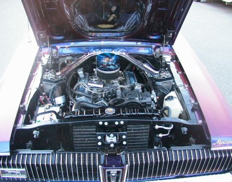 1968 Mercury Cougar - The engine bay of a 1968 Mercury Cougar is open, revealing its V8 engine and chrome details.