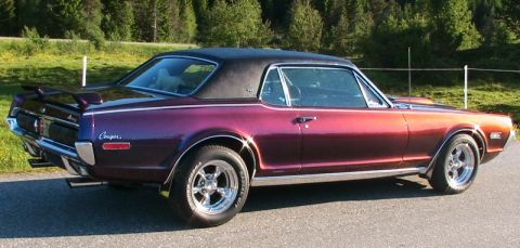 1968 Mercury Cougar - This 1968 Mercury Cougar features a distinctive purple paint job, a black vinyl roof, and a rear spoiler.
