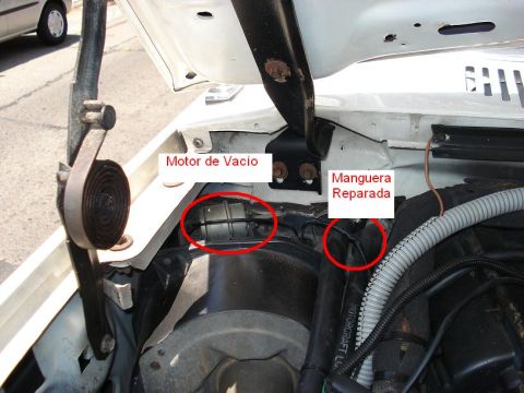 1986 Ford Bronco - Close-up of engine bay components, with Spanish text indicating vacuum motor and repaired hose.