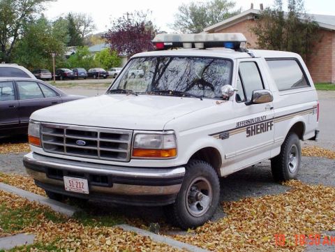 1986 Ford Bronco - Jefferson County Sheriff's Ford Bronco SUV parked on a street with fallen leaves.
