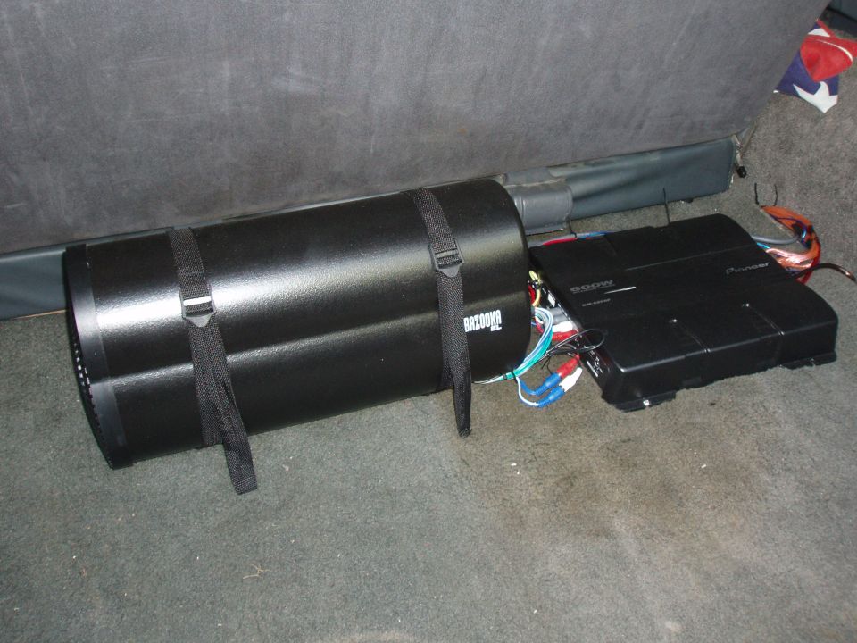 Subwoofer and amplifier installed in a vehicle's cargo area