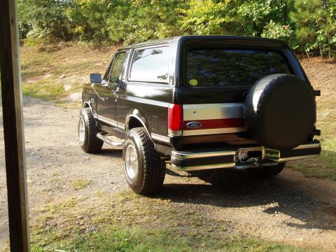 1989 Ford Bronco - This black 1989 Ford Bronco is viewed from the rear, a spare tire mounted on the tailgate.