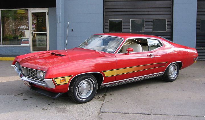 Red 1970 Ford Ranchero with yellow side stripe and hood scoop