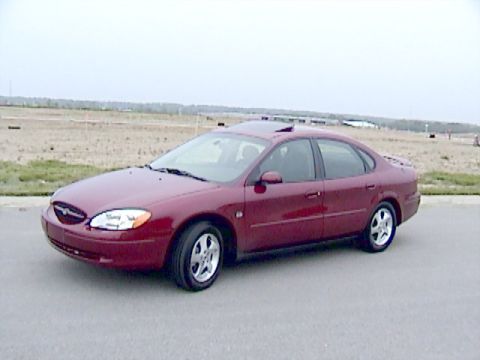 2002 Ford Taurus - A maroon 2002 Ford Taurus sedan is shown from a 3/4 front angle on a paved surface.