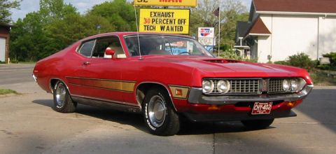 1972 Ford Ranchero - This red 1970 Ford Torino GT coupe features a distinctive grille and gold side stripe.