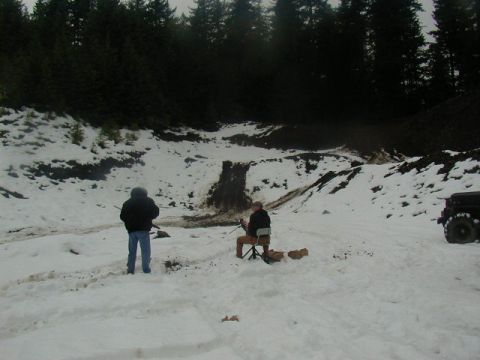 1994 Ford Explorer - A dark SUV is visible in the snow, with two individuals standing in the wintry landscape.