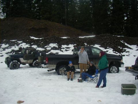 1994 Ford Explorer - Several people are gathered in the snow around two vehicles, a pickup truck and a Jeep.