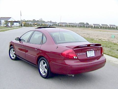 2002 Ford Taurus - Burgundy 2002 Ford Taurus sedan parked on a paved road with a field in the background.
