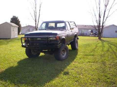 1991 Ford Bronco - This Ford Bronco is parked on a grassy lawn with houses in the background.