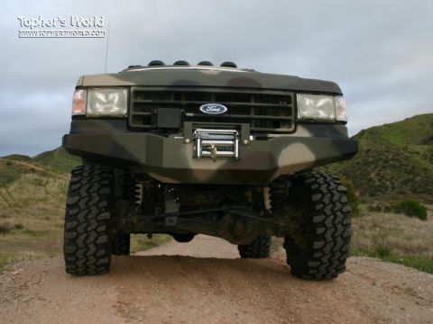 1991 Ford Bronco - This Ford truck features a custom bumper and off-road tires, ready for terrain.