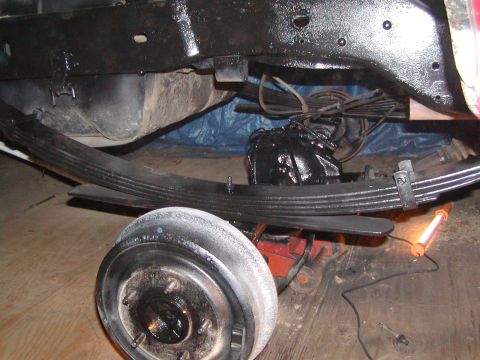 1991 Ford Bronco - Close-up view of the rear leaf spring suspension and brake drum assembly.