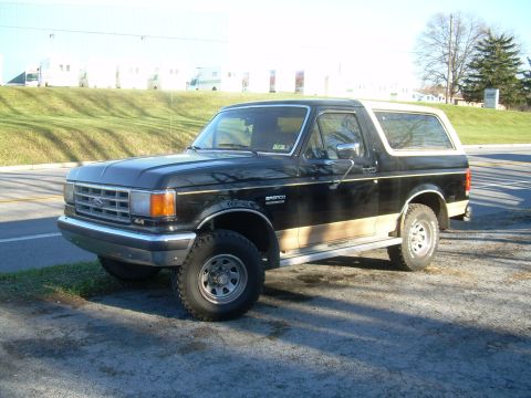 1992 Ford Bronco - This Ford Bronco features a two-tone paint scheme with black on top and tan on the lower body panels.