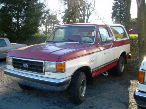 1992 Ford Bronco - This two-tone Ford Bronco is parked in a driveway on a sunny day.