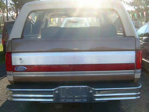 1992 Ford Bronco - Rear view of a 1992 Ford Bronco, showing its distinctive taillights and chrome bumper.