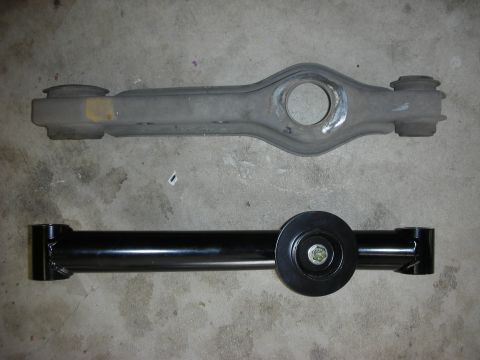 1990 Ford Mustang - A comparison of an old and new suspension control arm, likely for a vehicle's rear axle.