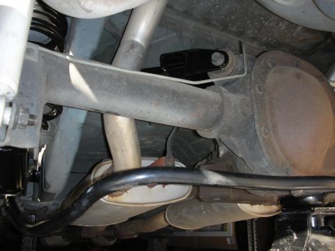 1990 Ford Mustang - Underside view of a 1990 Ford Mustang's rear axle and suspension system, showing a recently installed sway bar.