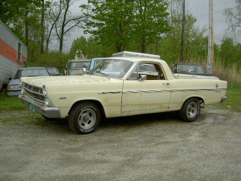 1967 Ford Ranchero - This 1967 Ford Ranchero is seen from a three-quarter front angle, parked in a gravel lot with other vehicles in the background.