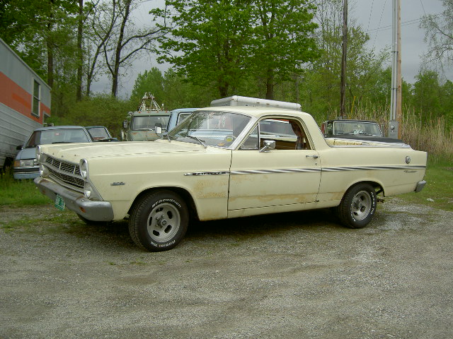 Cream 1967 Ford Ranchero with roof rack, parked outdoors