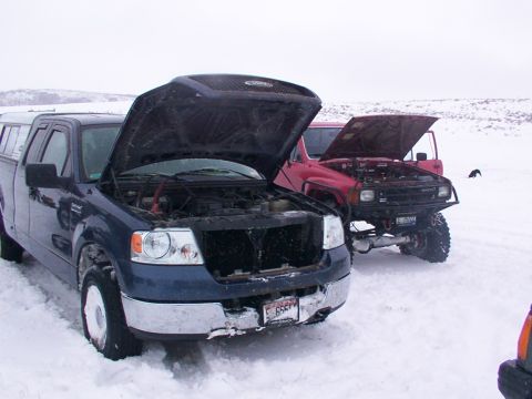 2003 Ford Ranger - Two trucks sit in the snow with their hoods open, suggesting a mechanical issue during a winter outing.