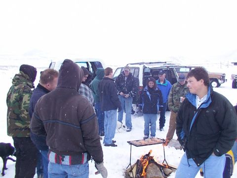 2003 Ford Ranger - People gather in a snowy outdoor scene around a fire and grill, with multiple vehicles visible.