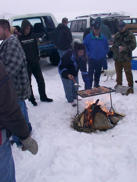 2003 Ford Ranger - Winter gathering with a campfire and grill, multiple vehicles present in the snowy scene.
