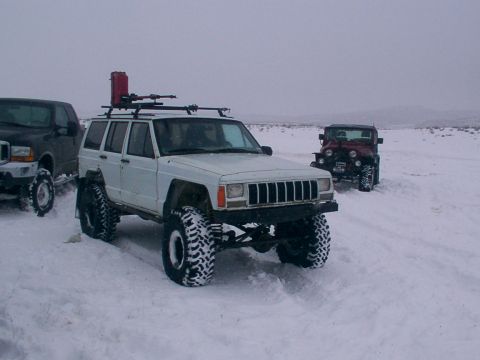 2003 Ford Ranger - Several off-road vehicles are parked in a snowy landscape under an overcast sky.