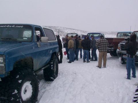 2003 Ford Ranger - A group of people stand around several trucks and a blue SUV in a snowy landscape.